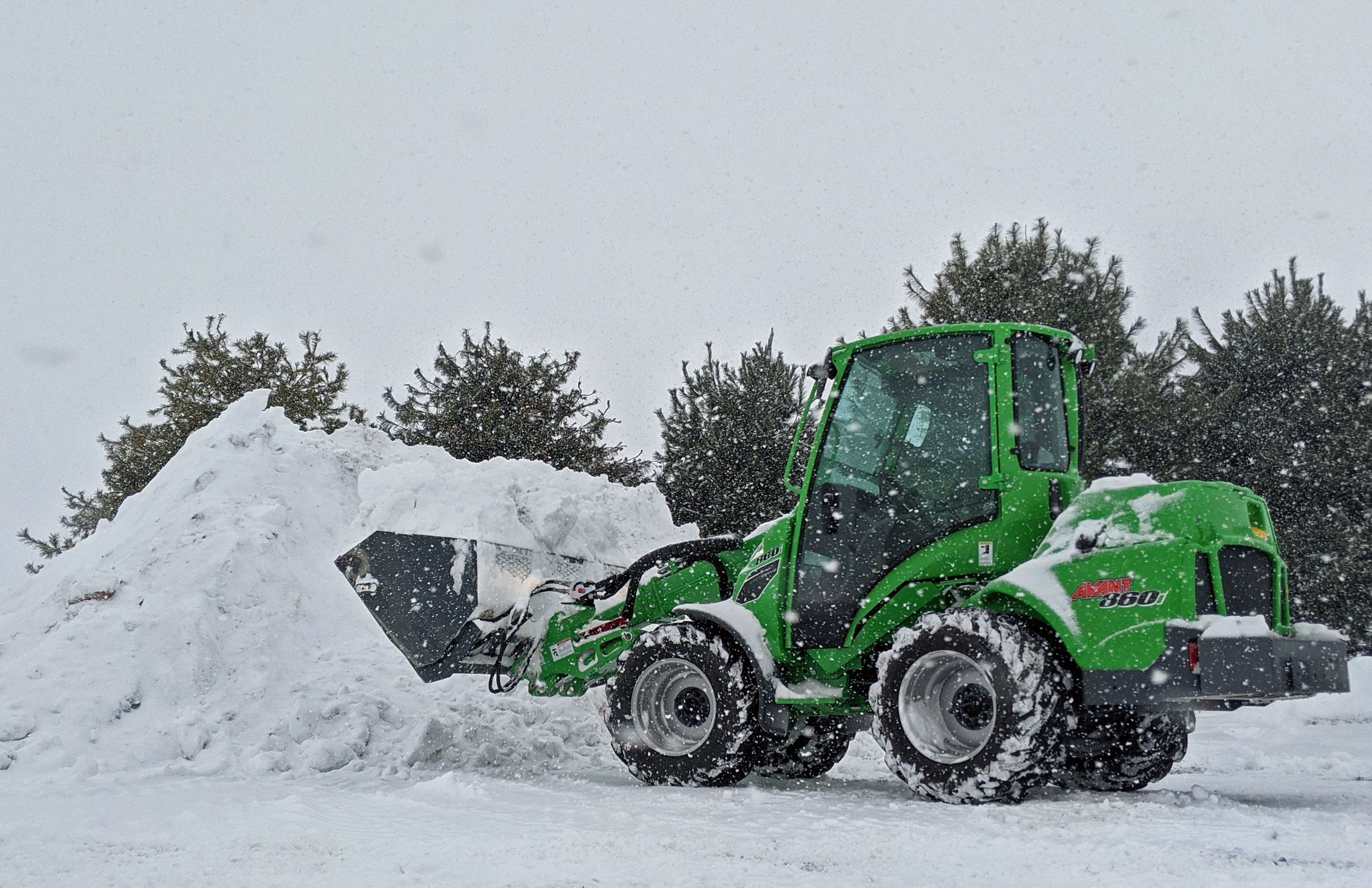 Front-Loader Dumping Snow on Large Snow Pile